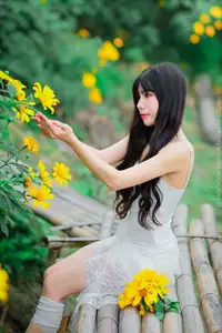 Graceful Young Woman in White Dress Amidst Vibrant Yellow Flowers 1000026997 - image 3