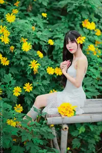 Graceful Young Woman in White Dress Amidst Vibrant Yellow Flowers 1000026997 - image 0