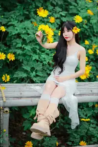 Graceful Young Woman in White Dress Amidst Vibrant Yellow Flowers 1000026997 - image 2