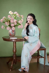 Radiant Elegance in Traditional Blue Attire and Spring Blooms - image 1