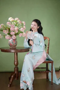 Radiant Elegance in Traditional Blue Attire and Spring Blooms - image 9