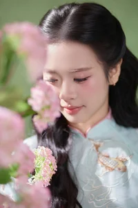 Radiant Elegance in Traditional Blue Attire and Spring Blooms - image 6