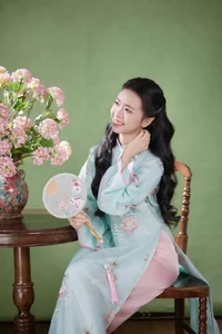 Radiant Elegance in Traditional Blue Attire and Spring Blooms - image 7