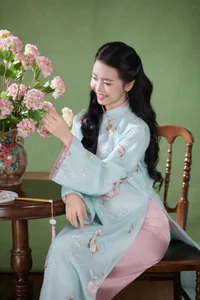 Radiant Elegance in Traditional Blue Attire and Spring Blooms - image 4