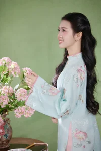 Radiant Elegance in Traditional Blue Attire and Spring Blooms - image 3