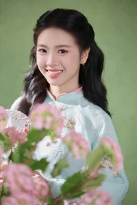 Radiant Elegance in Traditional Blue Attire and Spring Blooms - image 2