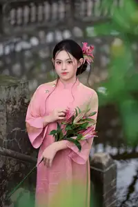 Elegant Pink Ao Dai Amidst Ancient Architecture Capturing Timeless Traditional Beauty - image 1