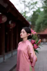 Elegant Pink Ao Dai Amidst Ancient Architecture Capturing Timeless Traditional Beauty - image 0