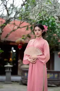 Elegant Pink Ao Dai Amidst Ancient Architecture Capturing Timeless Traditional Beauty - image 10