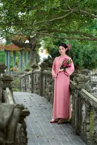 Elegant Pink Ao Dai Amidst Ancient Architecture Capturing Timeless Traditional Beauty - image 2