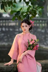 Elegant Pink Ao Dai Amidst Ancient Architecture Capturing Timeless Traditional Beauty - image 3