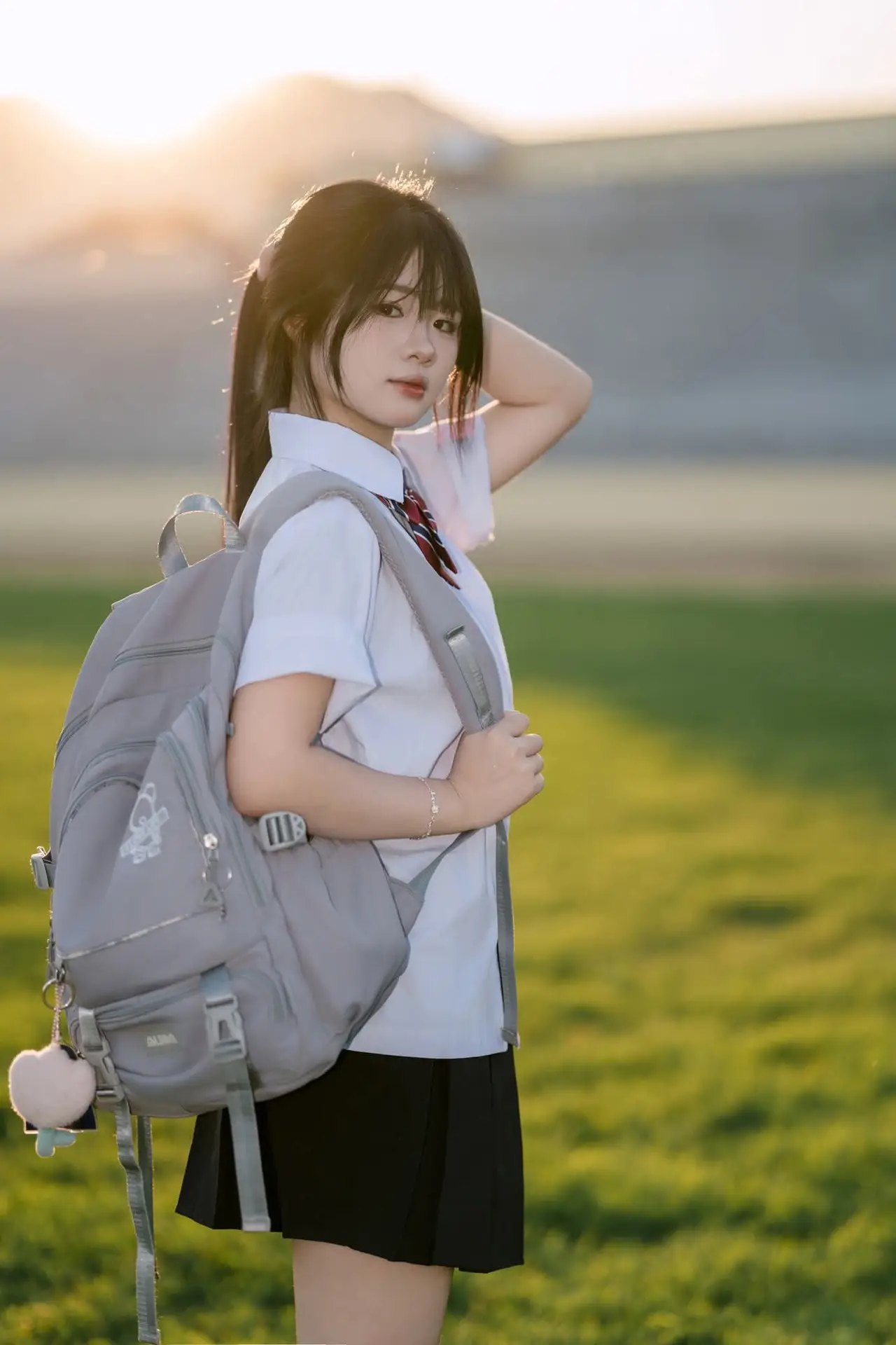 Youthful Schoolgirl in Uniform: Serene Golden Hour Beauty, a Glimpse into Nostalgic Student Life.