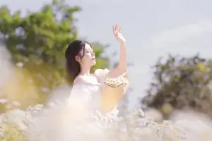 Serene Beauty: Young Woman in White Flower Field, Embracing Tranquility Under Gentle Sunlight - image 5