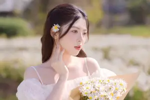 Serene Beauty: Young Woman in White Flower Field, Embracing Tranquility Under Gentle Sunlight - image 7