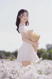 Serene Beauty: Young Woman in White Flower Field, Embracing Tranquility Under Gentle Sunlight - image 11