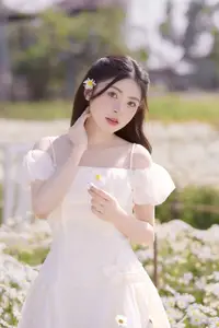 Serene Beauty: Young Woman in White Flower Field, Embracing Tranquility Under Gentle Sunlight - image 9