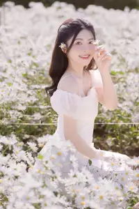 Serene Beauty: Young Woman in White Flower Field, Embracing Tranquility Under Gentle Sunlight - image 6