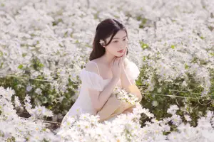 Serene Beauty: Young Woman in White Flower Field, Embracing Tranquility Under Gentle Sunlight - image 4