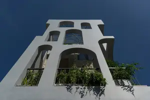Light-Filled Tube House: Discover Unique Arched Facade & Green Urban Living - image 3