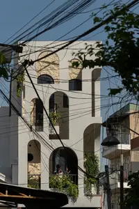 Light-Filled Tube House: Discover Unique Arched Facade & Green Urban Living - image 8