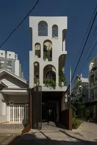 Light-Filled Tube House: Discover Unique Arched Facade & Green Urban Living - image 10