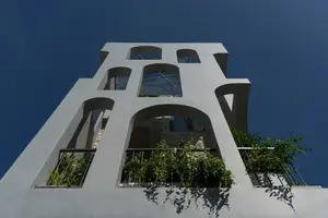 Light-Filled Tube House: Discover Unique Arched Facade & Green Urban Living - image 9