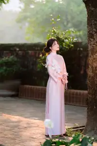 Elegant Vietnamese Beauty: Young Woman Gracefully Posing in Pink Ao Dai with White Orchids 1000026874 - image 11