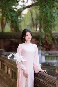 Elegant Vietnamese Beauty: Young Woman Gracefully Posing in Pink Ao Dai with White Orchids 1000026874 - image 12