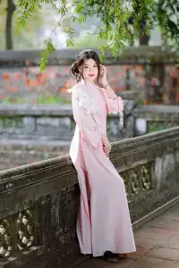 Elegant Vietnamese Beauty: Young Woman Gracefully Posing in Pink Ao Dai with White Orchids 1000026874 - image 2