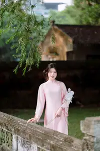Elegant Vietnamese Beauty: Young Woman Gracefully Posing in Pink Ao Dai with White Orchids 1000026874 - image 9