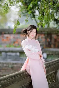 Elegant Vietnamese Beauty: Young Woman Gracefully Posing in Pink Ao Dai with White Orchids 1000026874 - image 7