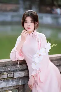 Elegant Vietnamese Beauty: Young Woman Gracefully Posing in Pink Ao Dai with White Orchids 1000026874 - image 6