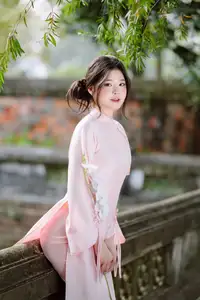 Elegant Vietnamese Beauty: Young Woman Gracefully Posing in Pink Ao Dai with White Orchids 1000026874 - image 5