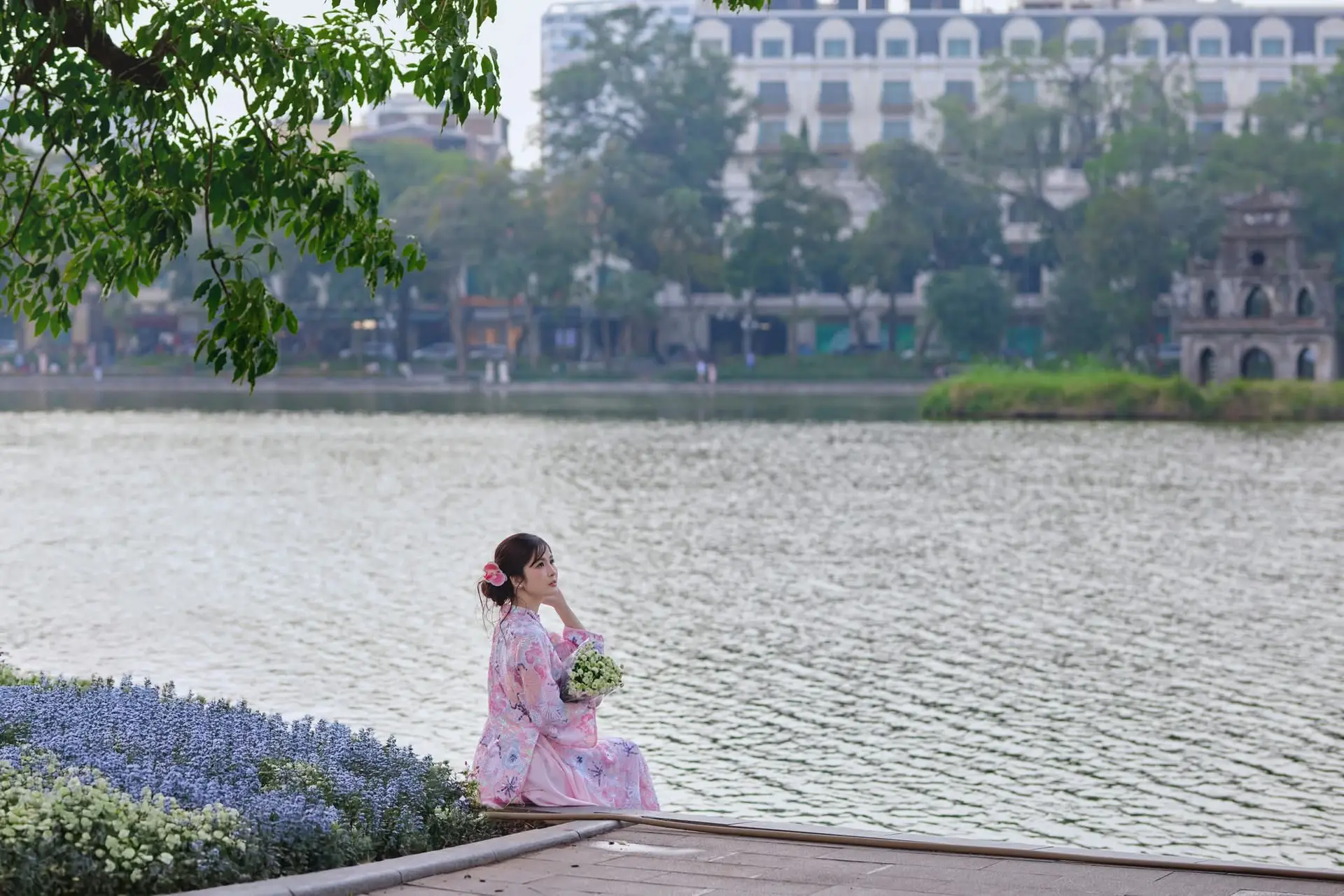 Elegant Asian Beauty: Graceful Woman in Modern Ao Dai by Serene Lakeside