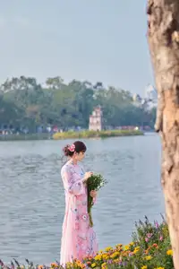 Elegant Asian Beauty: Graceful Woman in Modern Ao Dai by Serene Lakeside - image 3