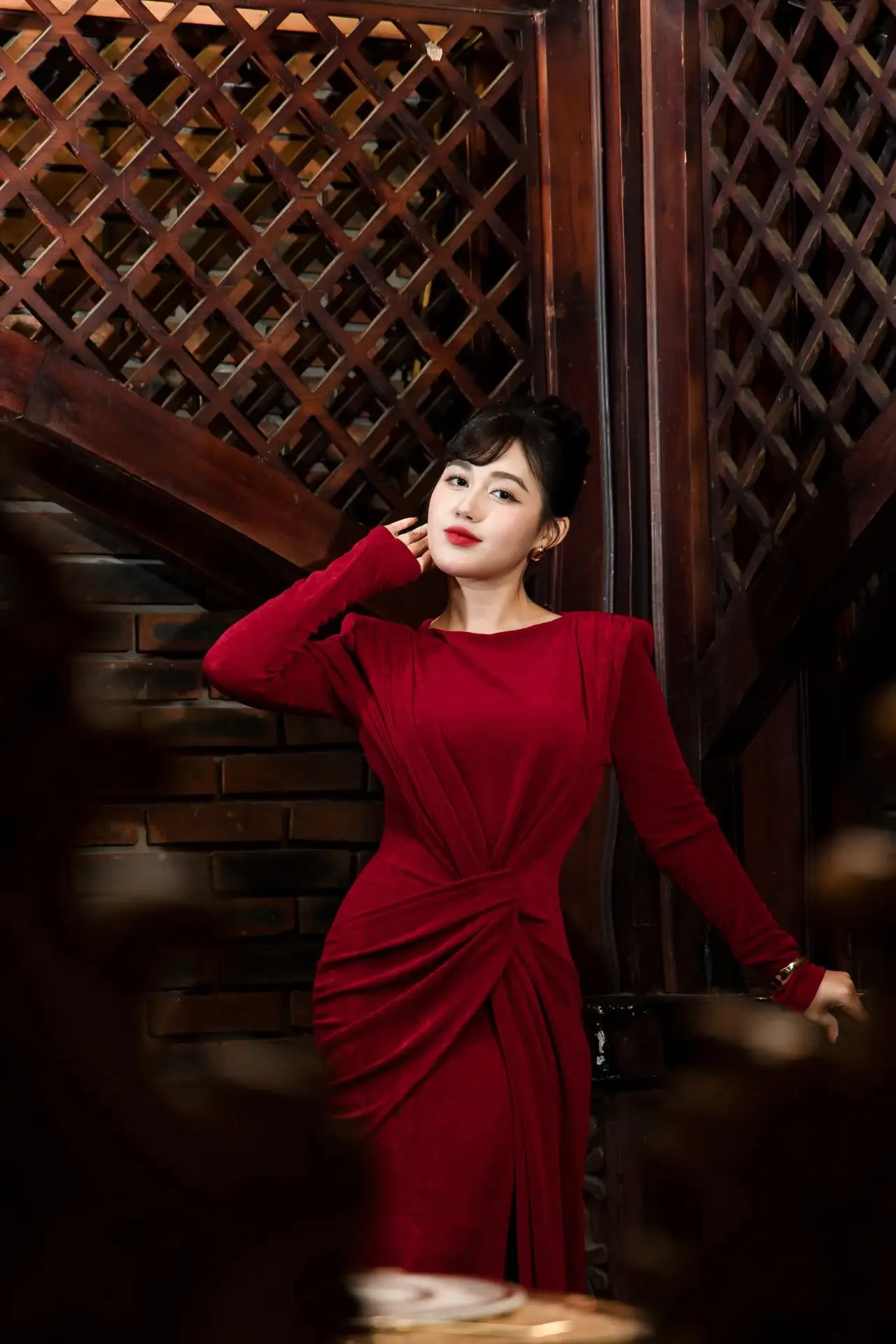 Captivating Asian Beauty: The Elegant Woman in Red with a Charming Smile and Confident Aura