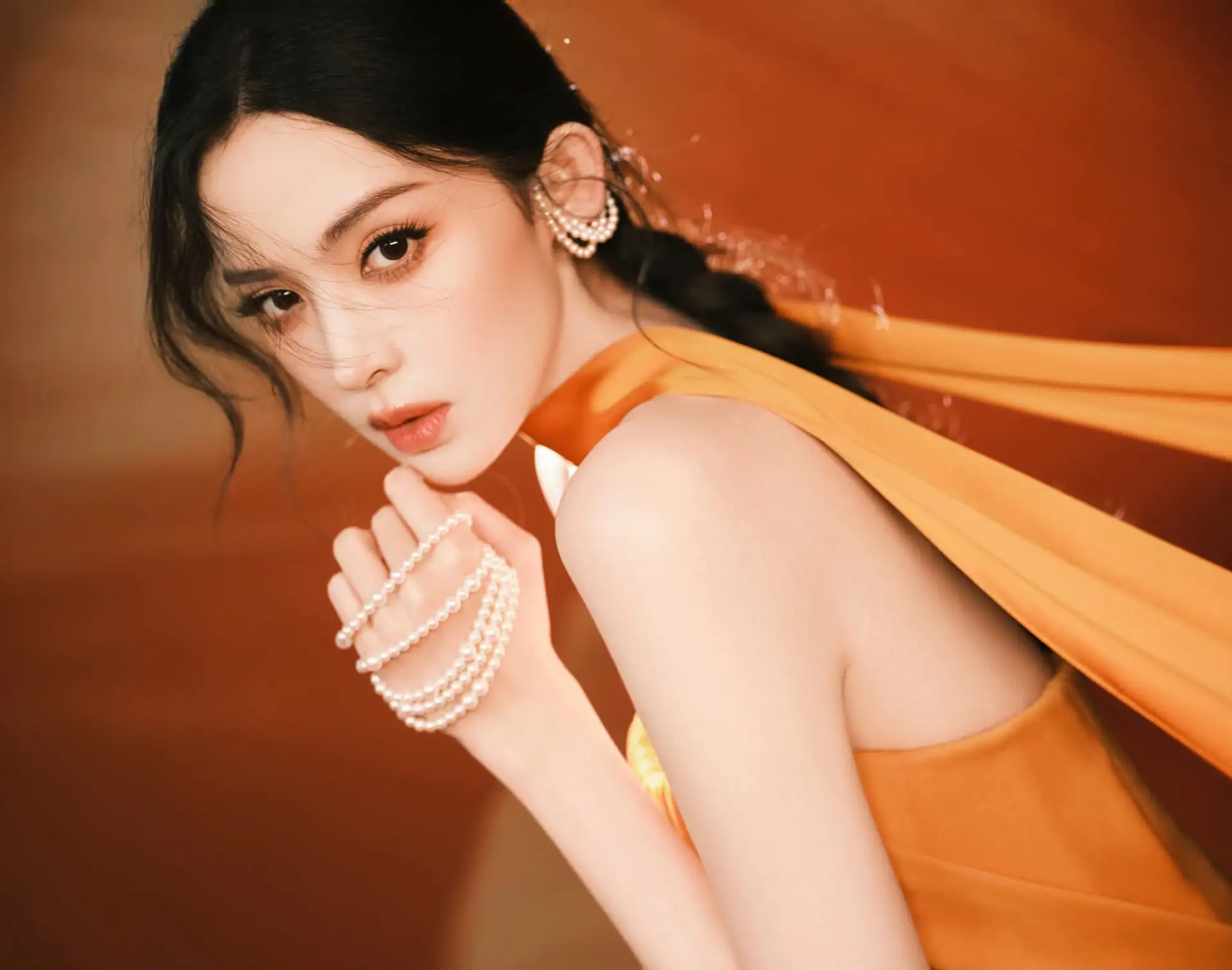 Captivating Beauty: Goddess in a Vibrant Orange Gown, Exuding Elegant Allure.