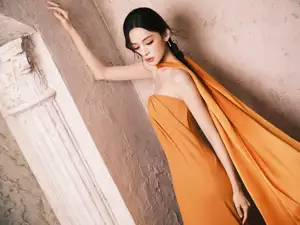 Captivating Beauty: Goddess in a Vibrant Orange Gown, Exuding Elegant Allure. - image 1
