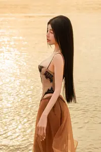Golden Hour Serenity: Young Woman's Graceful Beach Walk - image 6