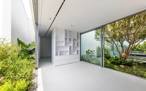 Minimalist White House Design in Ho Chi Minh City: A Serene Urban Oasis Featuring Lush Indoor Greenery and Modern Architecture - image 0