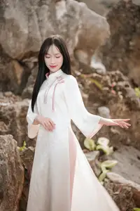 Timeless Elegance: Vietnamese Woman in Traditional Ao Dai Amidst Serene Backdrop - image 5