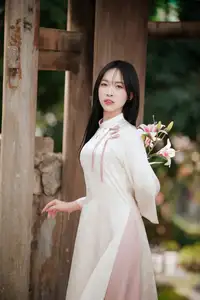 Timeless Elegance: Vietnamese Woman in Traditional Ao Dai Amidst Serene Backdrop - image 3