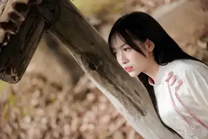 Timeless Elegance: Vietnamese Woman in Traditional Ao Dai Amidst Serene Backdrop - image 2