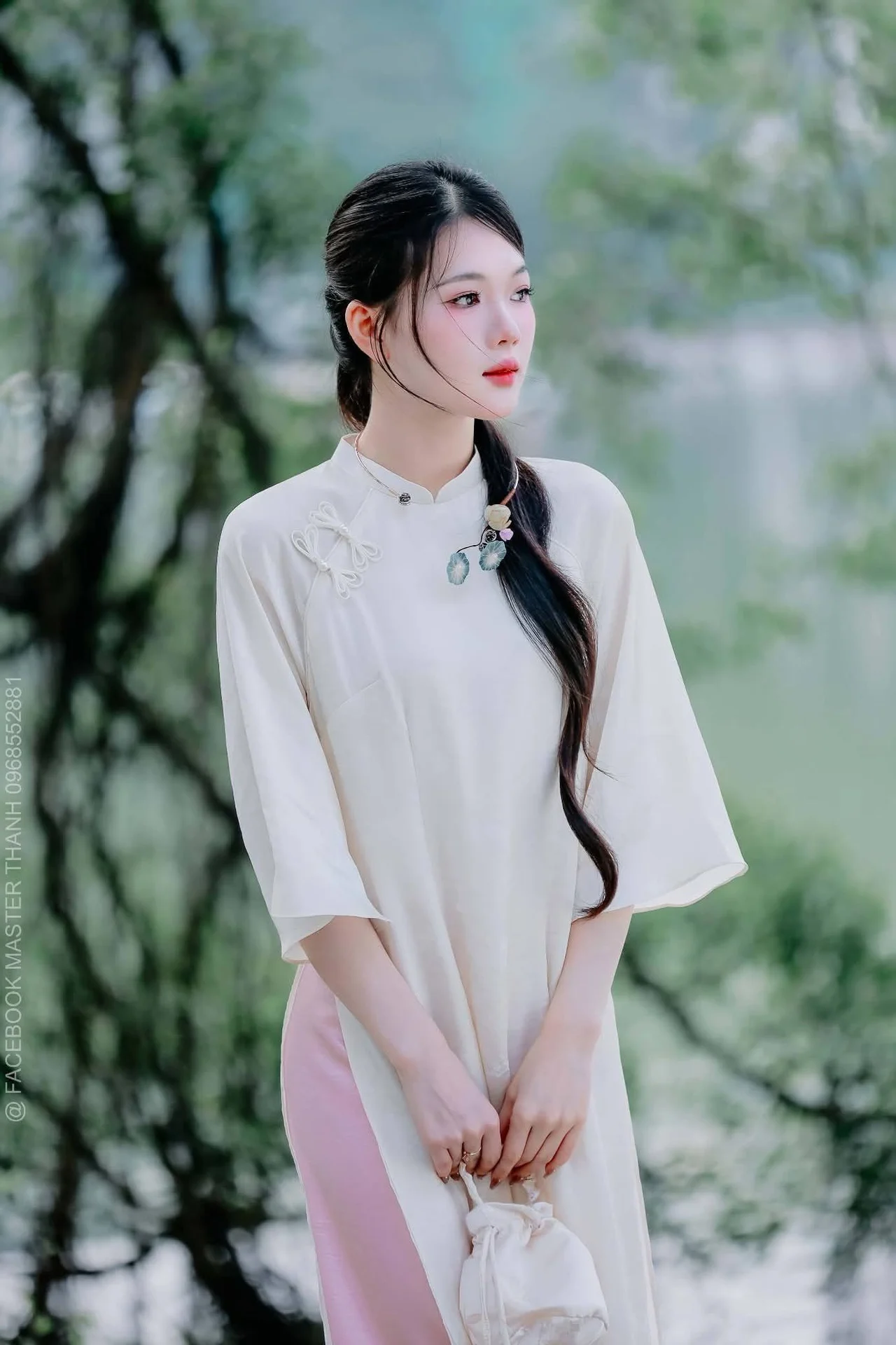 Elegant Beauty of a Vietnamese Woman in Ao Dai by a Peaceful Lake