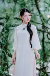 Elegant Beauty of a Vietnamese Woman in Ao Dai by a Peaceful Lake - image 2