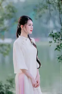 Elegant Beauty of a Vietnamese Woman in Ao Dai by a Peaceful Lake - image 4
