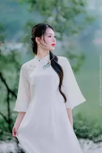 Elegant Beauty of a Vietnamese Woman in Ao Dai by a Peaceful Lake - image 3