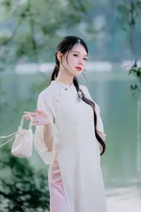 Elegant Beauty of a Vietnamese Woman in Ao Dai by a Peaceful Lake - image 5