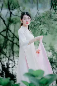 Elegant Beauty of a Vietnamese Woman in Ao Dai by a Peaceful Lake - image 1