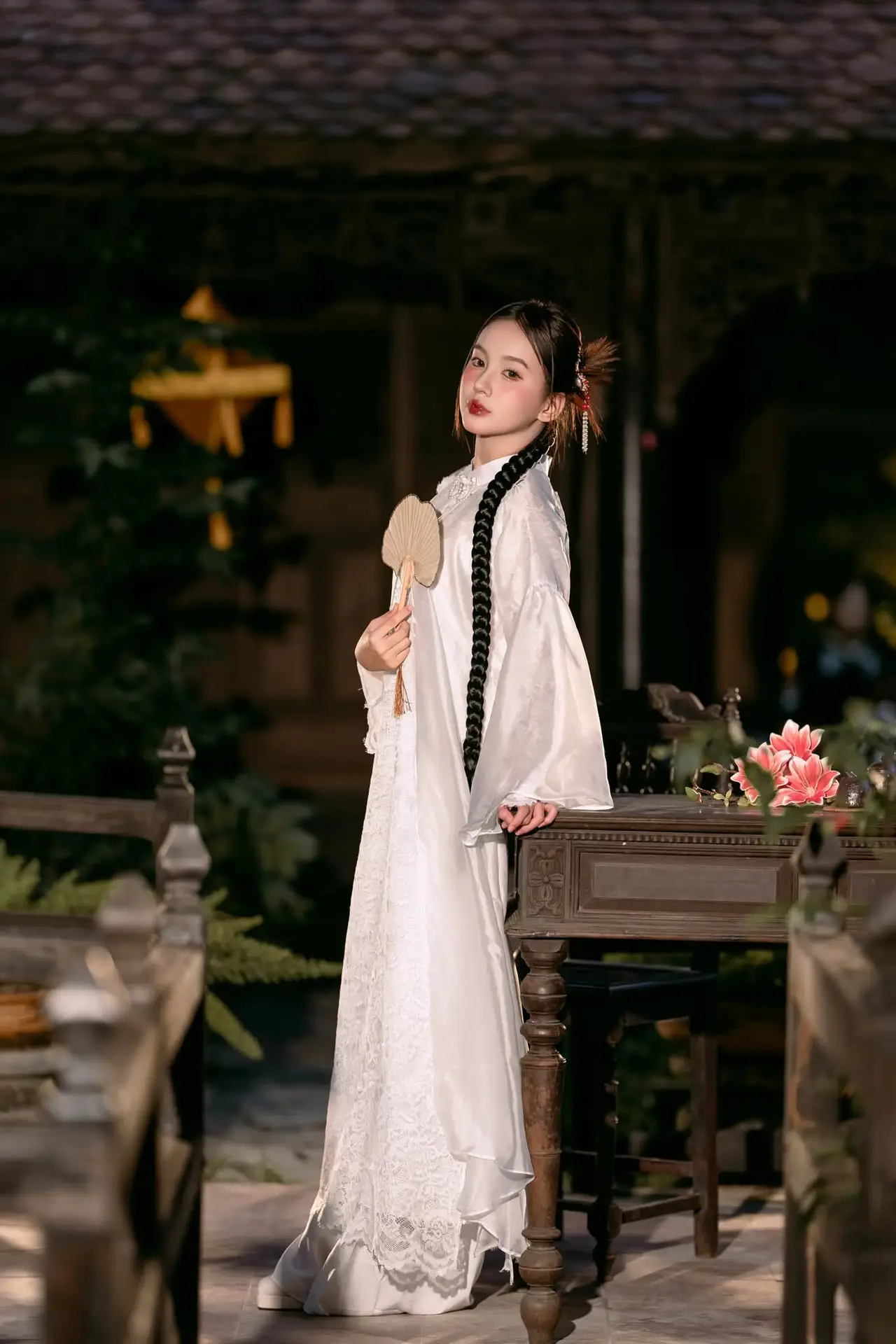 Enchanting Vietnamese Beauty A Girl with Long Braids in Traditional Attire on a Magical Night